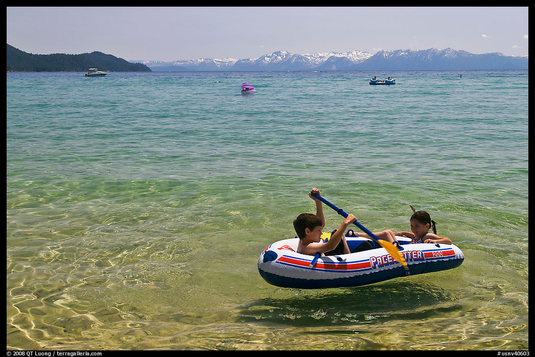 Children playing in inflatable boat, Sand Harbor, Lake Tahoe-Nevada State Park, Nevada. USA