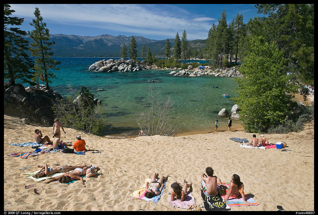 Young people sunbathing on sandy beach, Sand Harbor, Lake Tahoe, Nevada. USA