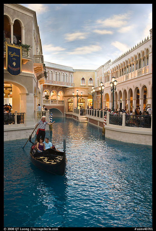 Gondolier singing song to couple during ride inside Venetian casino. Las Vegas, Nevada, USA