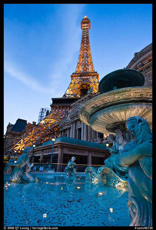 Fountain and Eiffel Tower replica at dusk, Paris casino. Las Vegas, Nevada, USA
