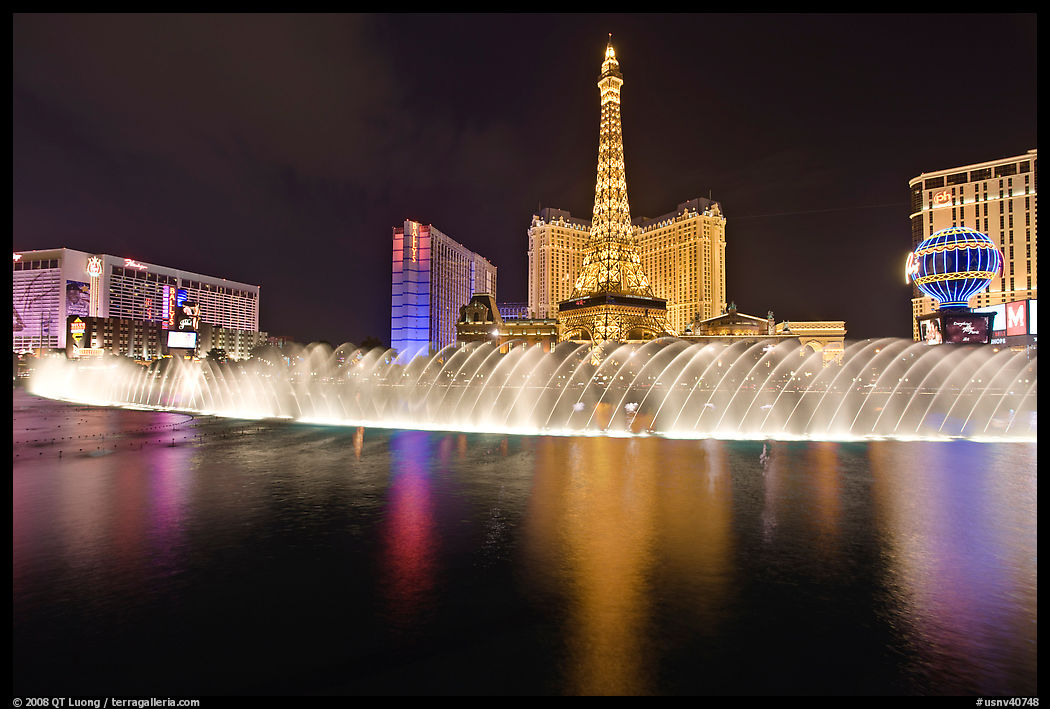 Bellagio dancing fountains and hotels reflected in lake. Las Vegas, Nevada, USA