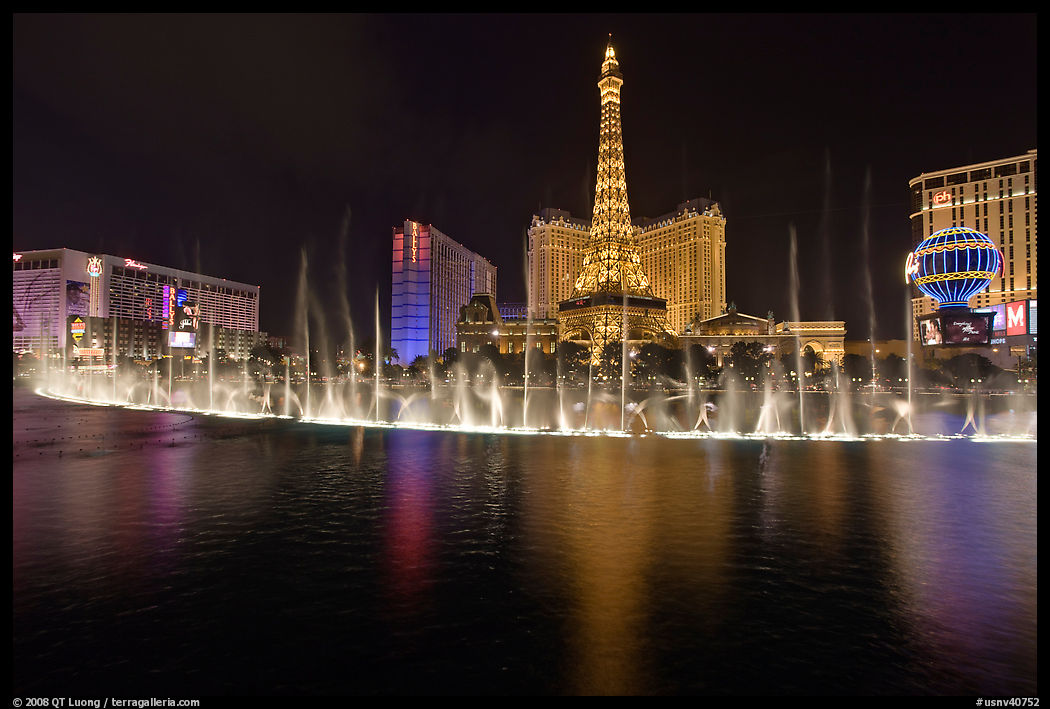 Bellagio dancing fountains and casinos reflected in lake. Las Vegas, Nevada, USA