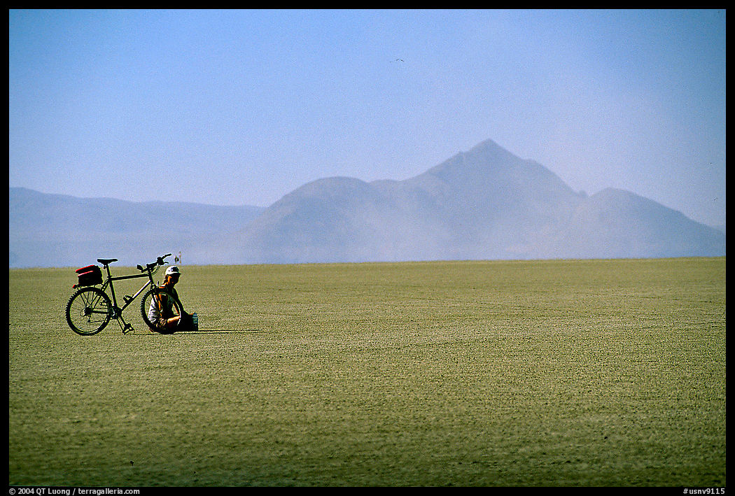 Bicyclist on the desert Playa. Black Rock Desert, Nevada, USA