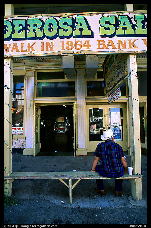 Man with cowboy hat sitting in front of a casino, Virginia City. USA