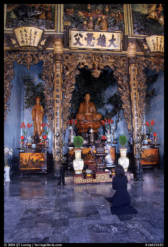 Woman praying at the altar. Ho Chi Minh City, Vietnam