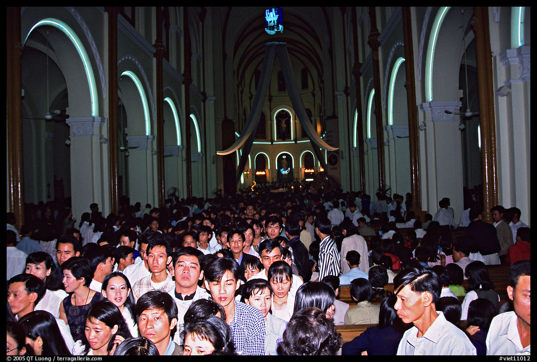 Crowds exit the Cathedral St Joseph at the end of the Christmas mass. Ho Chi Minh City, Vietnam