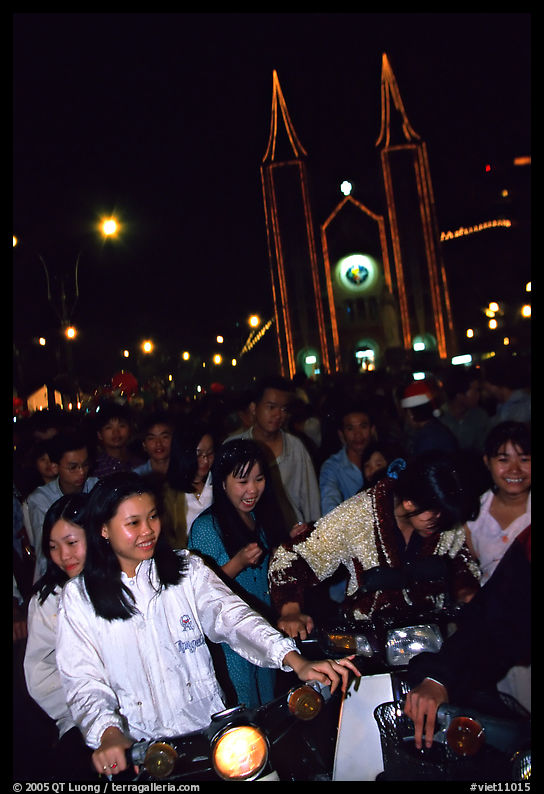 Women on motorbike in front of St Joseph Cathedral on Christmas eve. Ho Chi Minh City, Vietnam