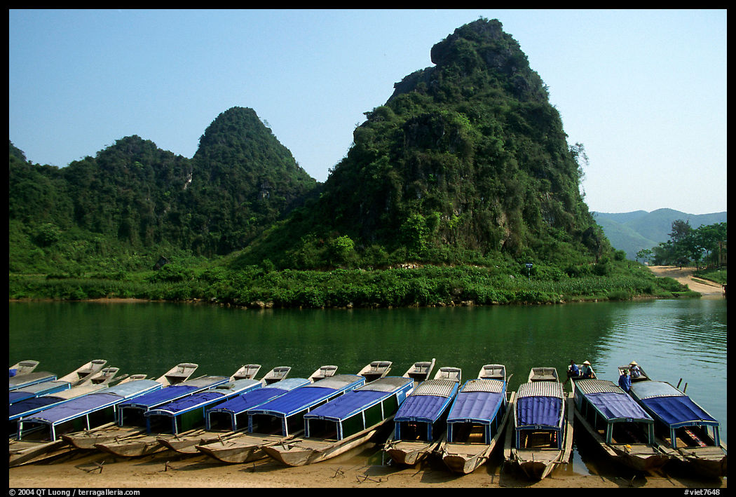 Tour boats and forest-covered limestone rocks, Son Trach. Vietnam