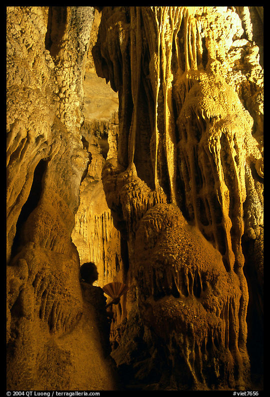 Visitor framed by cave formations, upper cave, Phong Nha Cave. Vietnam