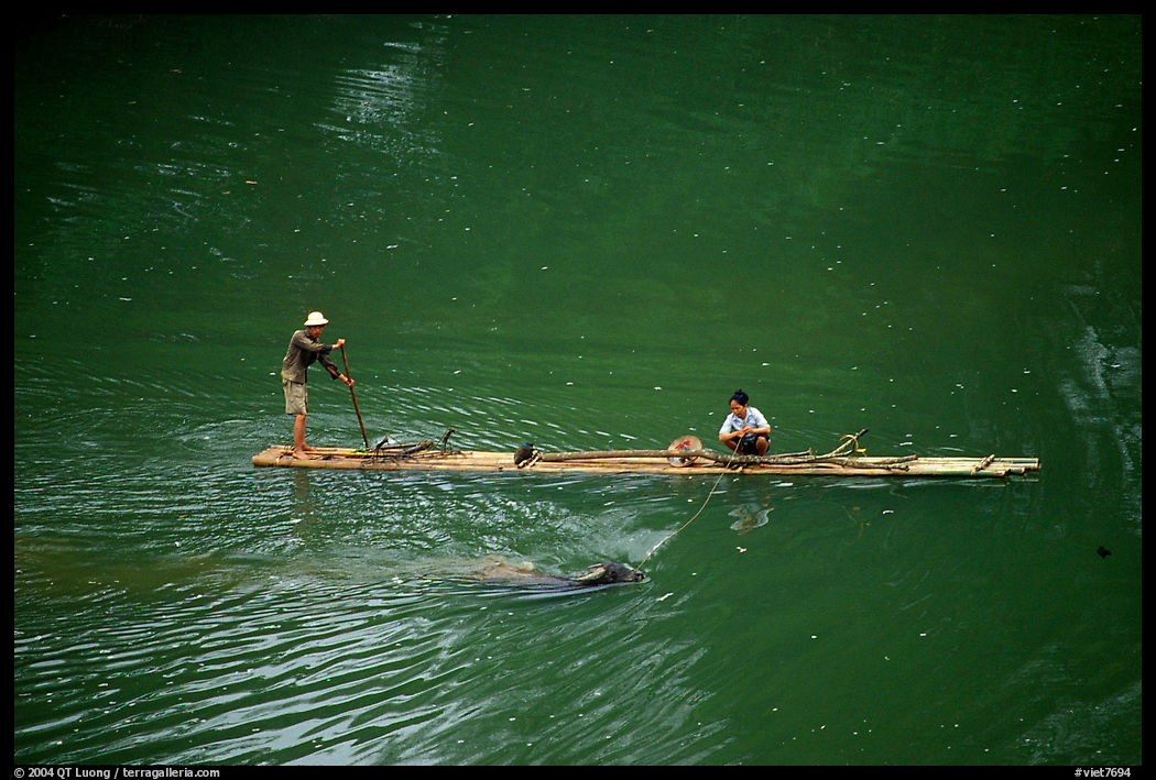 Crossing the Ky Cung  River on a narrow dugout boat. Northest Vietnam