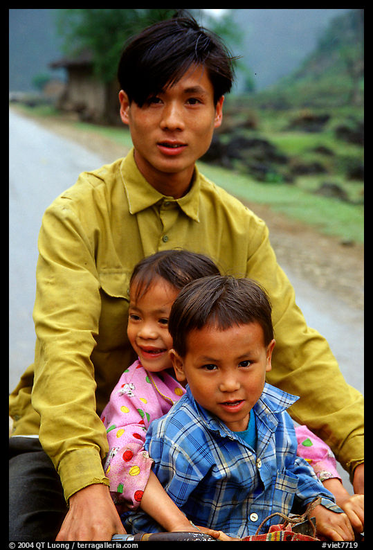 Young man carrying two kids on his bicycle. Northeast Vietnam