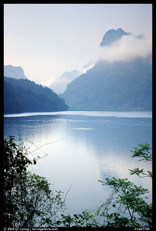 Morning mist on the tall cliffs surrounding Ba Be Lake. Northeast Vietnam
