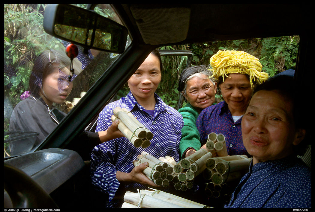 Peddlers offering sweet rice tubes for sale to a traveller. Vietnam
