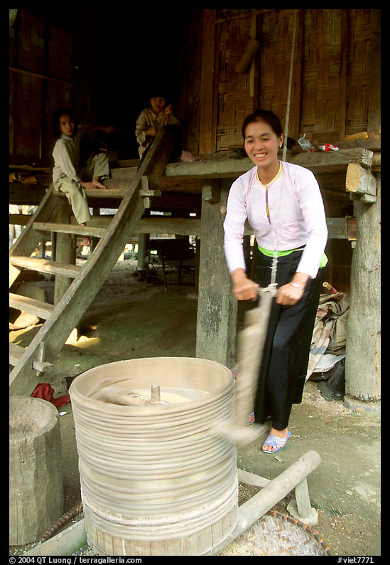 Woman of the Thai ethnicity milling grain, near Mai Chau. Northwest Vietnam