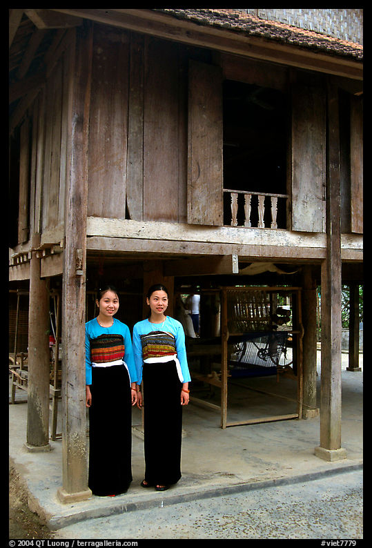 Two thai women standing in front of their stilt house, Ban Lac village. Northwest Vietnam