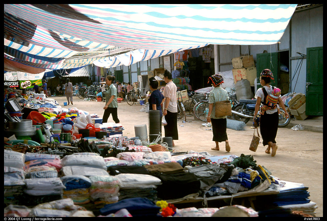 Thai women walk in a town market, near Son La. Northwest Vietnam