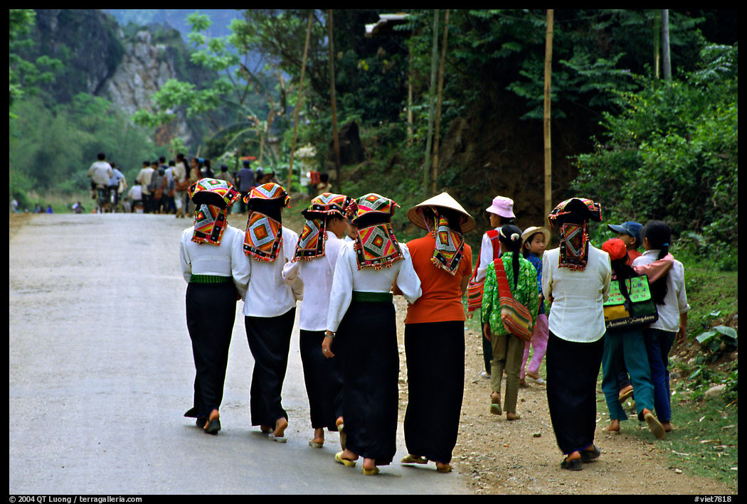 Young thai women walking on the road, between Son La and Tuan Chau. Northwest Vietnam
