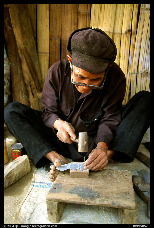 Dzao man crafting the decorative coins used in the children hats, between Tam Duong and Sapa. Northwest Vietnam