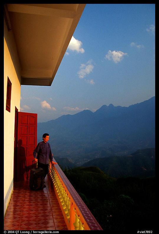 Traveler on a hotel balcony, looking at the Hoang Lien Mountains. Sapa, Vietnam