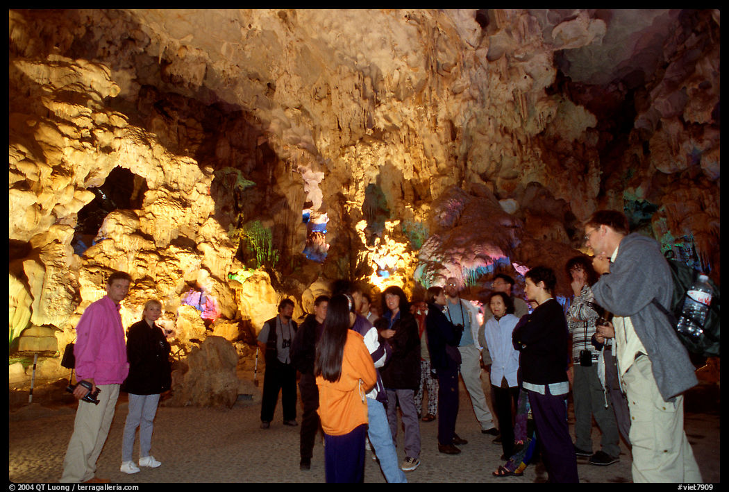 Tourists in an illuminated cave. Halong Bay, Vietnam