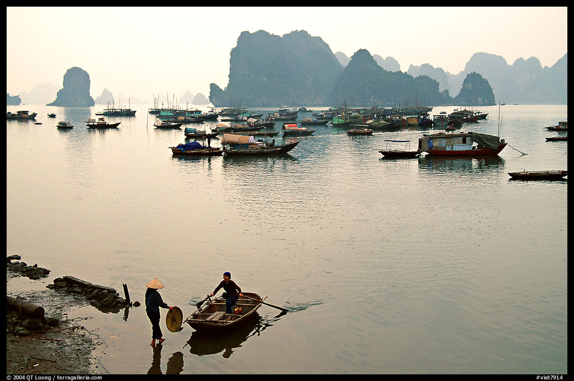 Woman catching a boat, with the bay in the background. Halong Bay, Vietnam