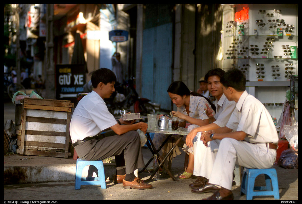 Enjoying a cafe on the streets, sitting on the typical tiny chairs. Ho Chi Minh City, Vietnam