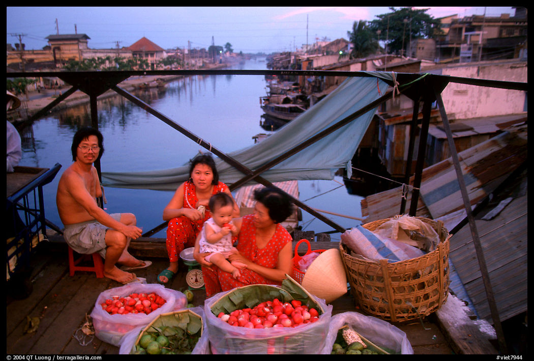 Family selling fruit on a bridge. Ho Chi Minh City, Vietnam