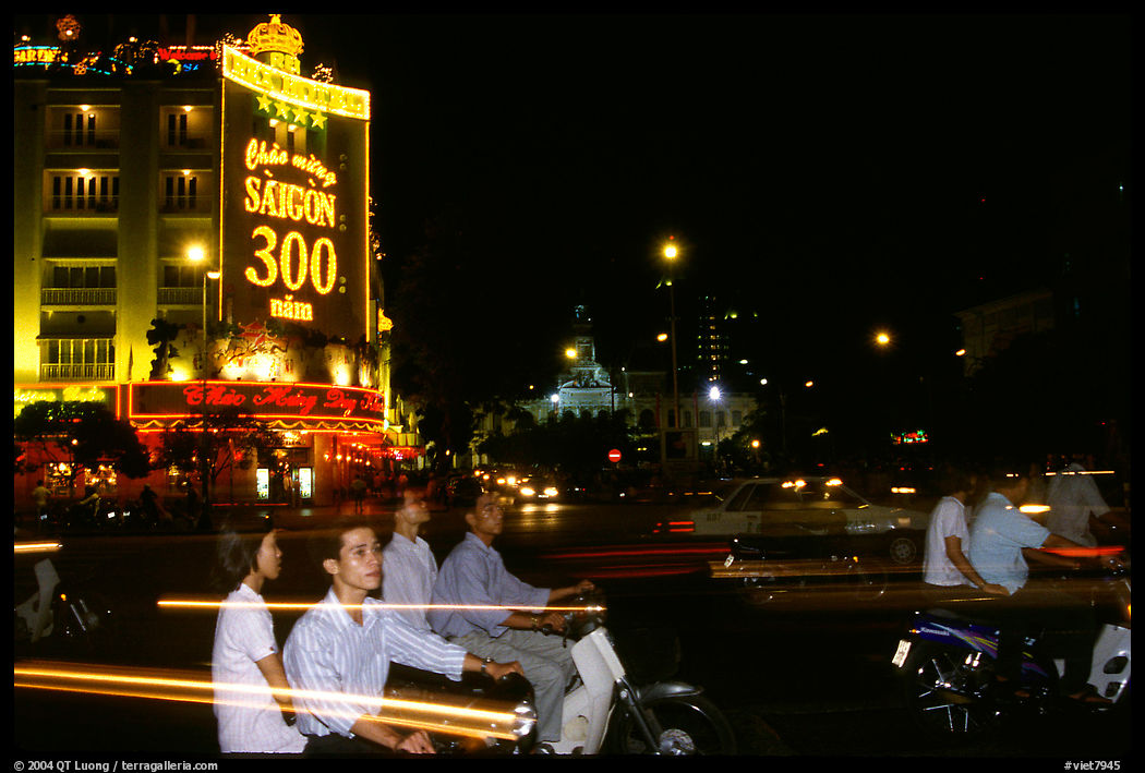 Night traffic in front of a sign celebrating the 300 years of Saigon. Ho Chi Minh City, Vietnam
