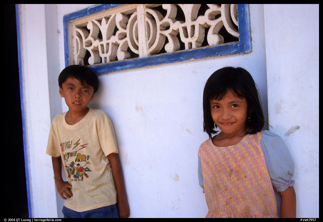 Two kids in front of a wall. Mekong Delta region, Vietnam