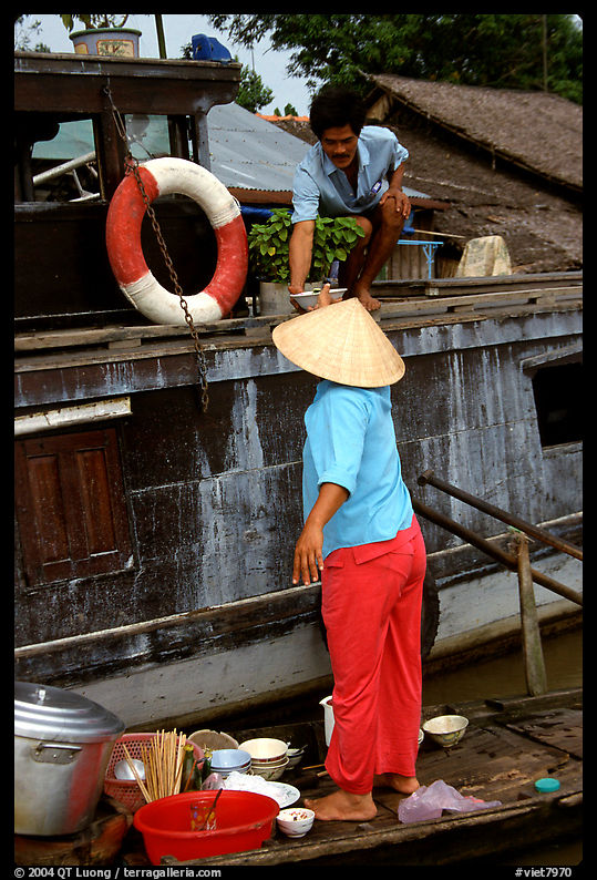 Passsing a bowl of pho from boat to boat. Can Tho, Vietnam
