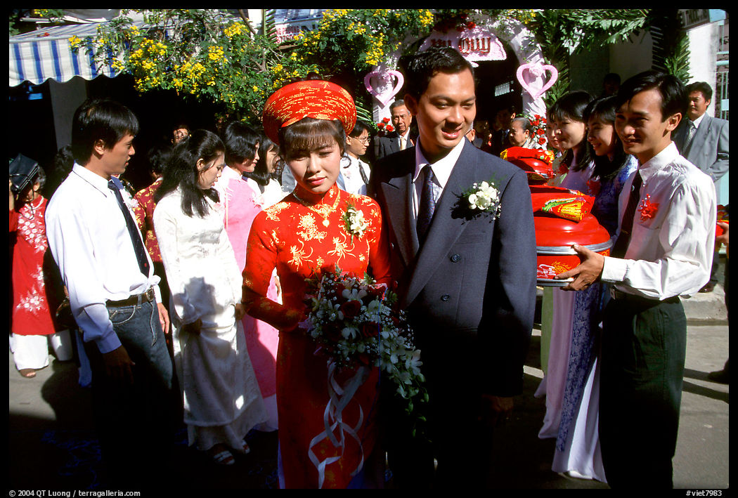 Newly-wed couple exit the bride's home. Ho Chi Minh City, Vietnam