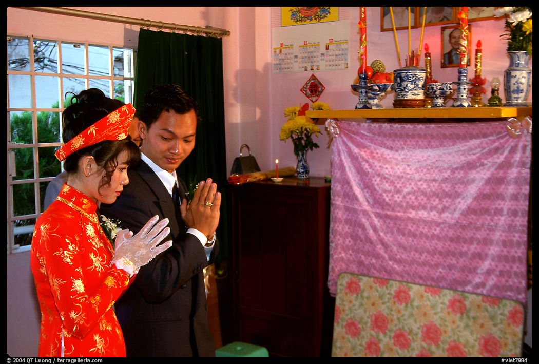 Newly-wed couple prays at the groom's ancestral altar. Ho Chi Minh City, Vietnam