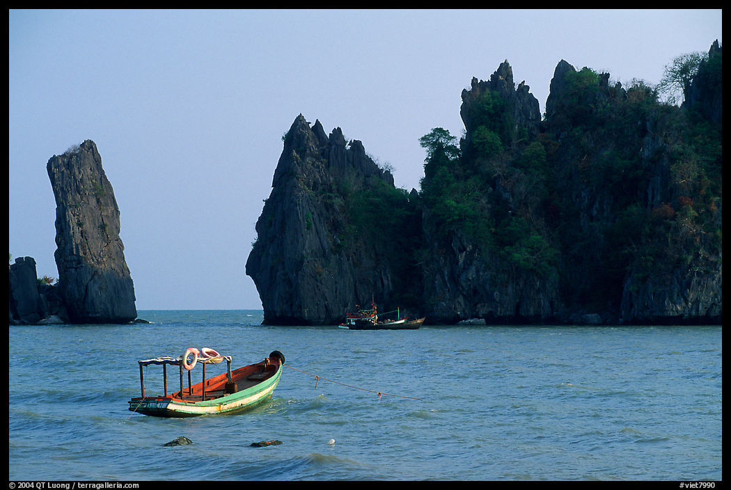 Small boats and offshore rock formations. Hong Chong Peninsula, Vietnam
