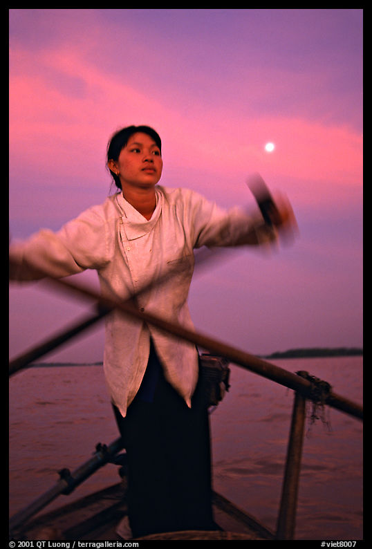 Woman using X-shaped paddles on the Mekong river, Can Tho. Vietnam