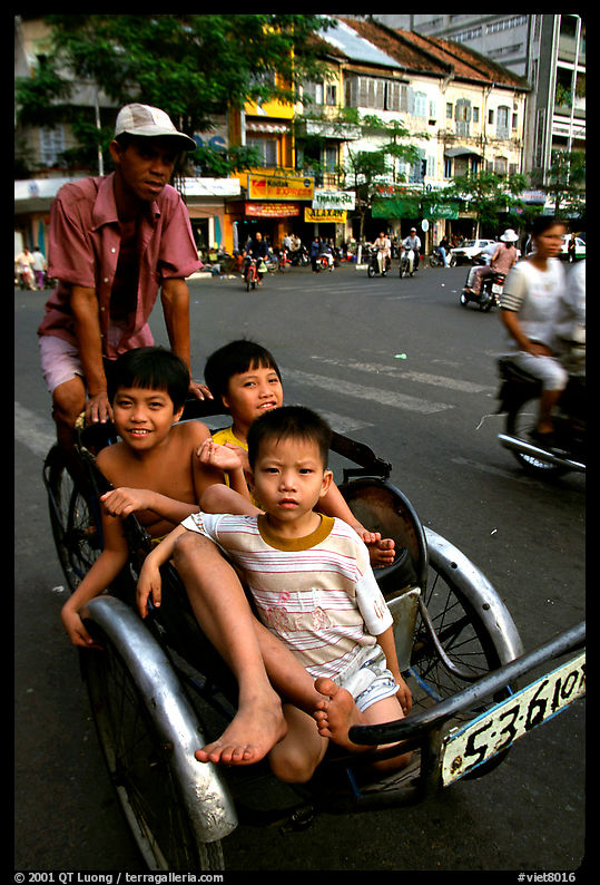 Kids sharing cyclo ride, Ho Chi Minh city. Vietnam