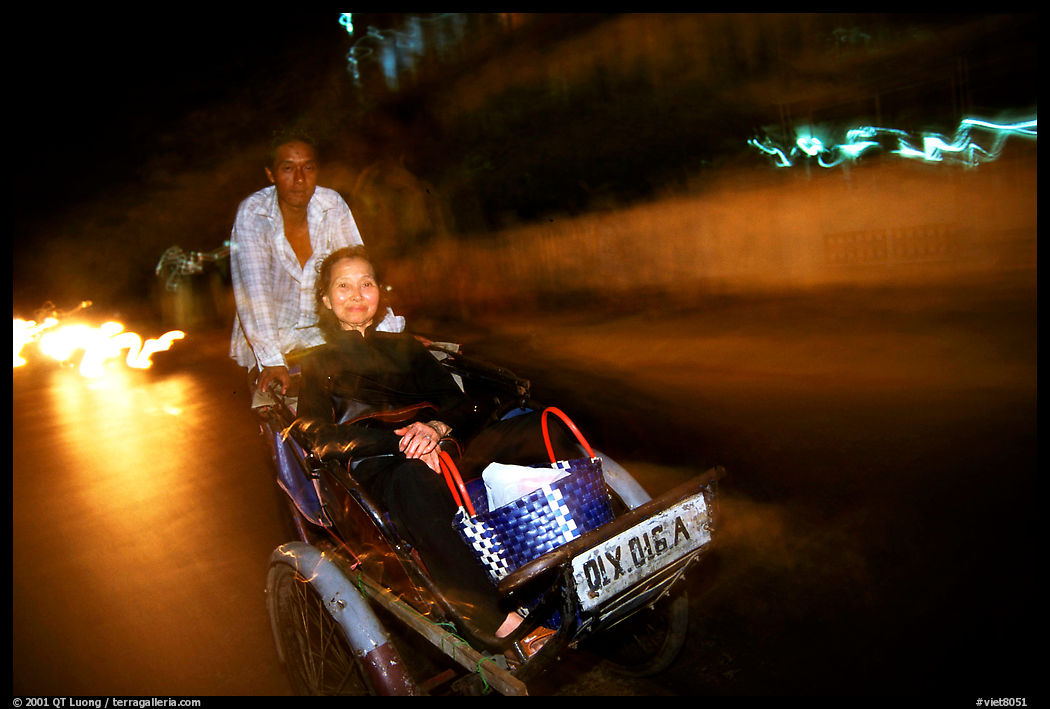 Enjoying the freshness of the night during a cyclo ride. Ho Chi Minh City, Vietnam