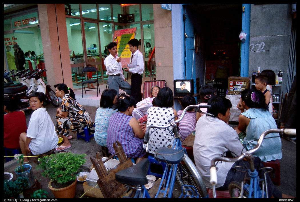 Watching TV on the street with the neighboors. Ho Chi Minh City, Vietnam