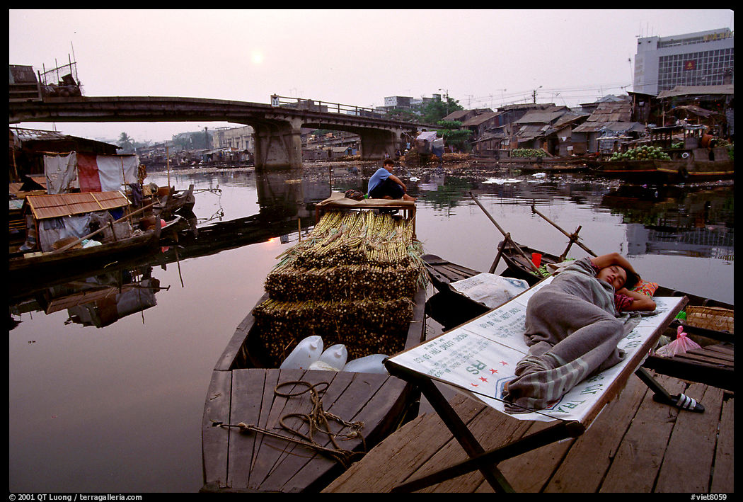 Sleeping out for the fresh air. Morning near the Saigon arroyo. Ho Chi Minh City, Vietnam
