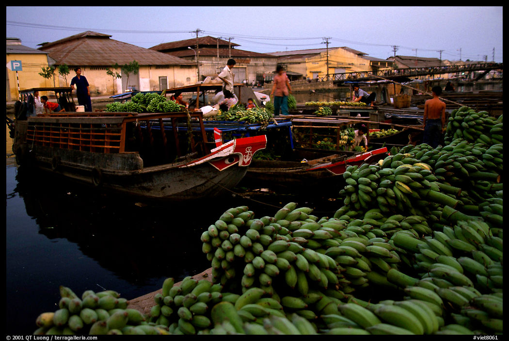 Boats bring loads of produce from the Delta on the Saigon arroyo. Ho Chi Minh City, Vietnam