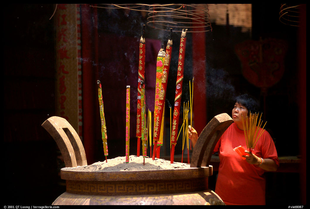Offering incense at a Chinese temple in Cho Lon. Ho Chi Minh City, Vietnam