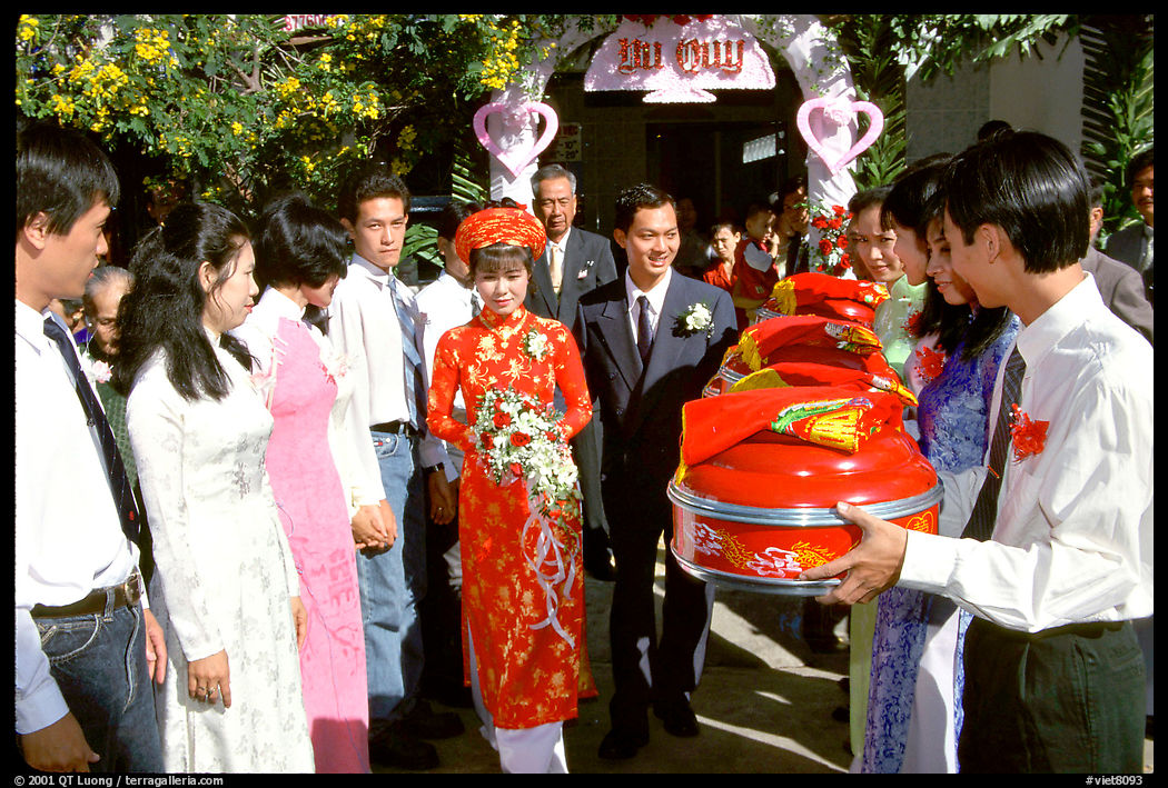 The exchange of gifts at a wedding, upon exiting the bride's home. The bride traditionaly wears red.. Ho Chi Minh City, Vietnam