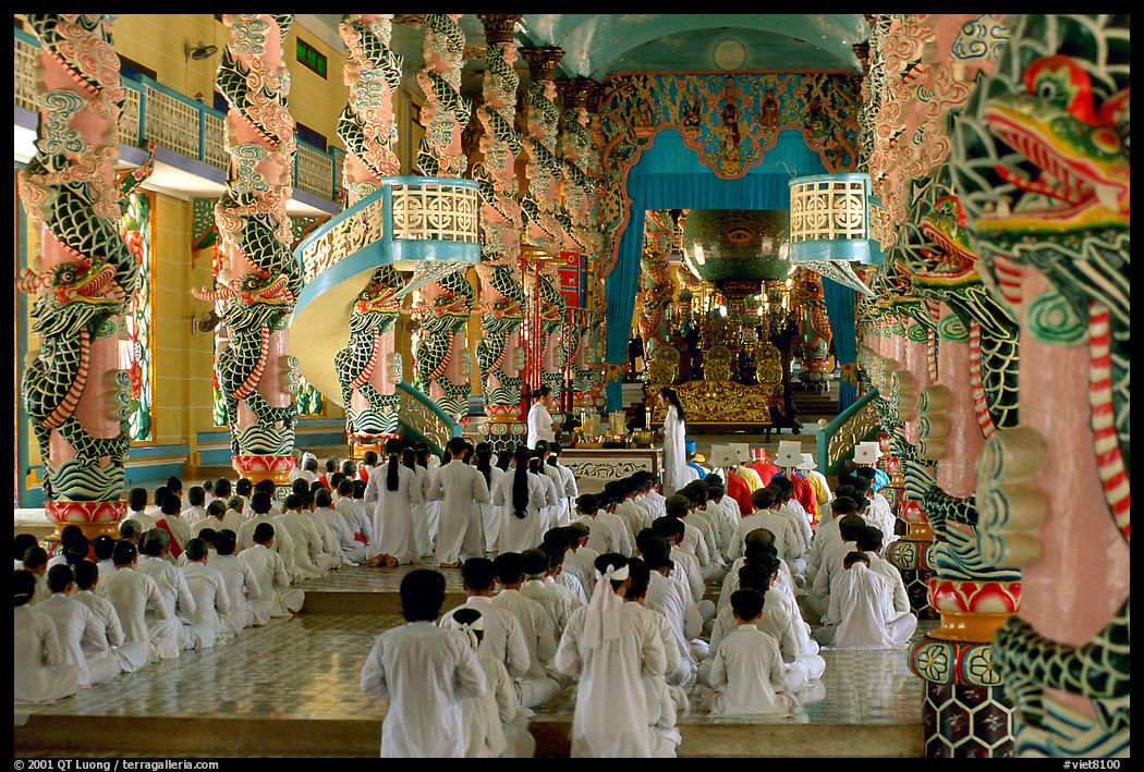 The noon ceremony, attended by priests inside the great Cao Dai temple. Tay Ninh, Vietnam