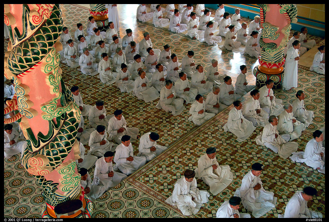 The noon ceremony, attended by priests inside the great Cao Dai temple. Tay Ninh, Vietnam