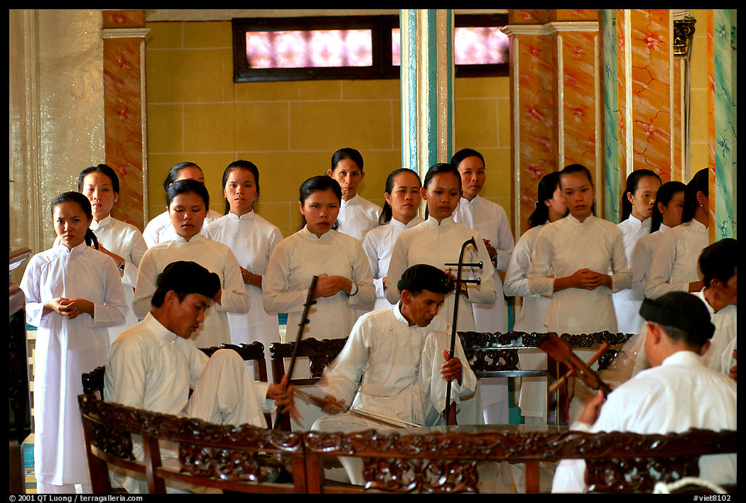 Traditional musicians during the noon ceremony. Tay Ninh, Vietnam