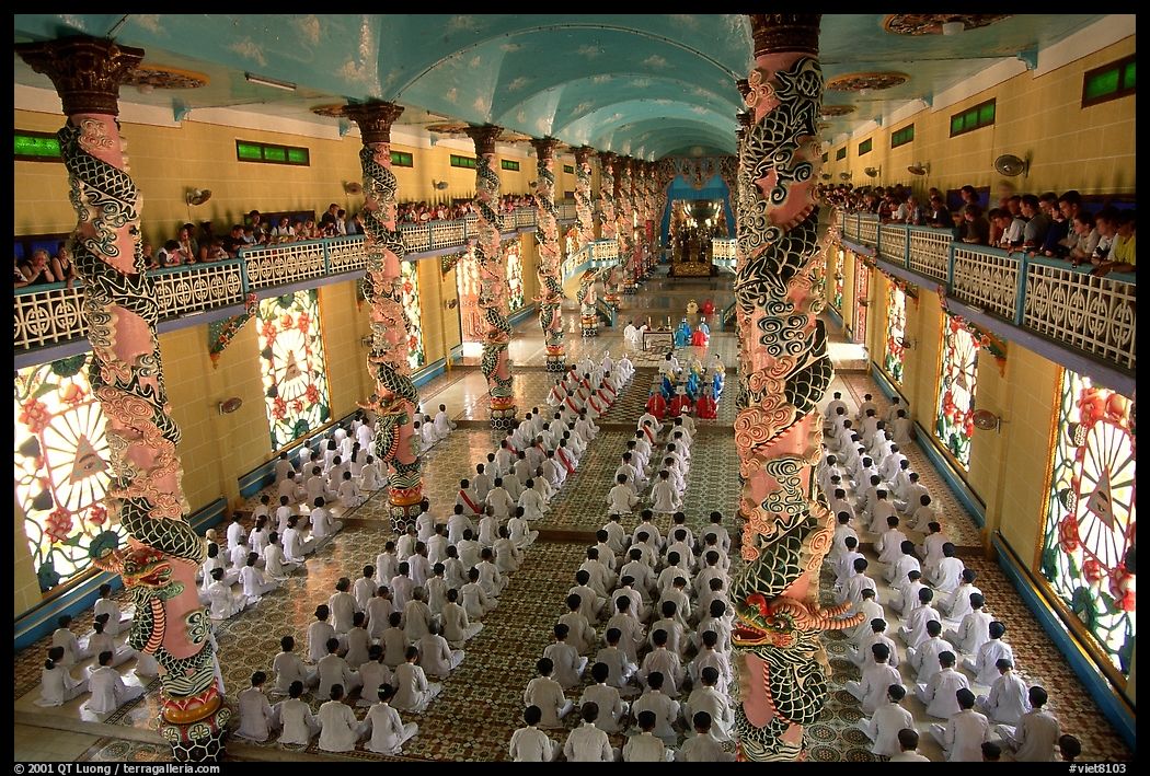 The noon ceremony, attended by priests inside the great Cao Dai temple. Tay Ninh, Vietnam