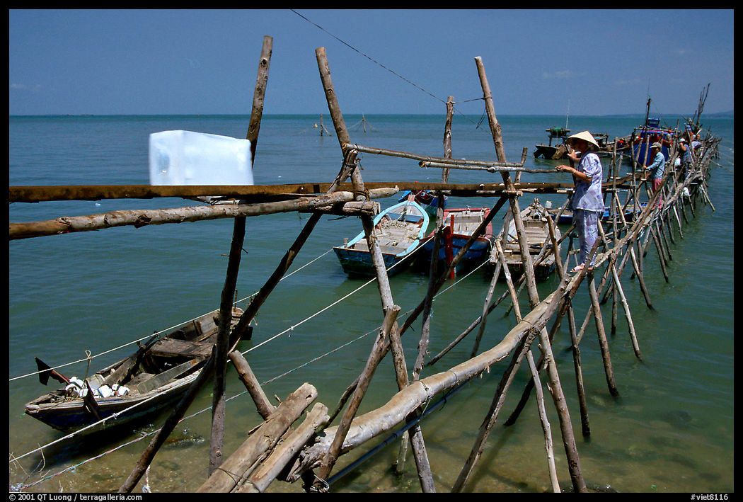 An ice block being loaded into a fishing boat. Vung Tau, Vietnam