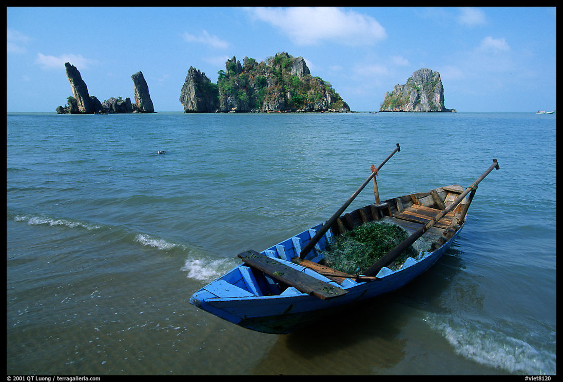 Boat and limestone towers, undeveloped beach. Hong Chong Peninsula, Vietnam