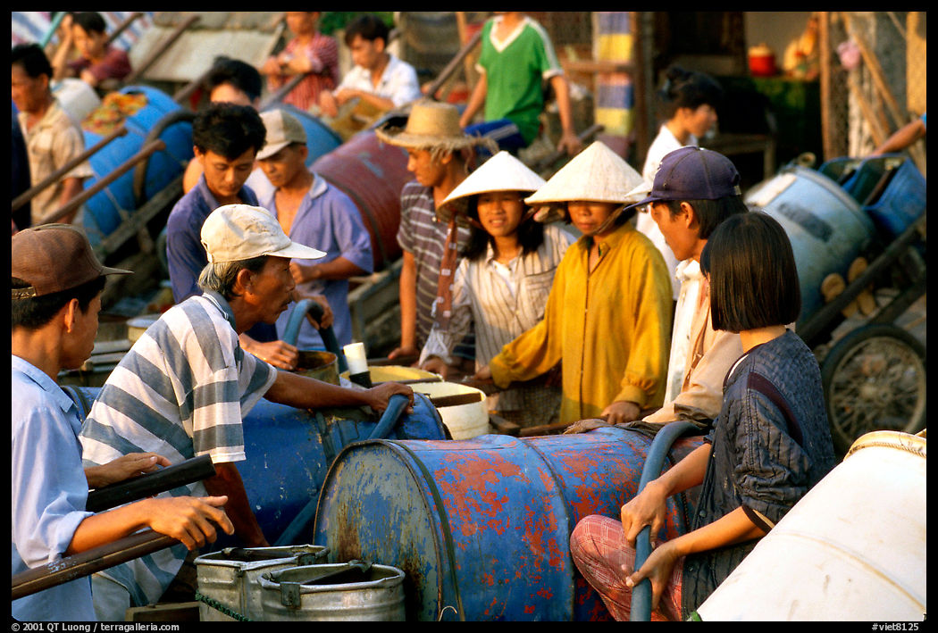 Filling up water tanks for the day. Ha Tien, Vietnam