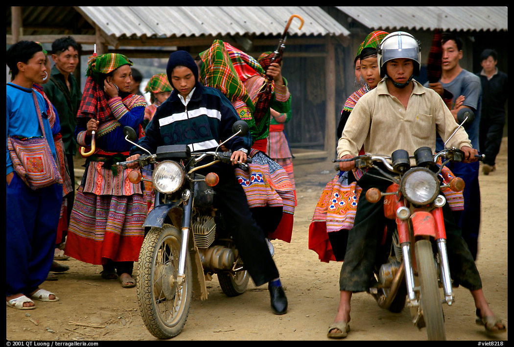 Flower Hmong women getting a ride on all-terrain russian-made motorbikes to the sunday market. Bac Ha, Vietnam
