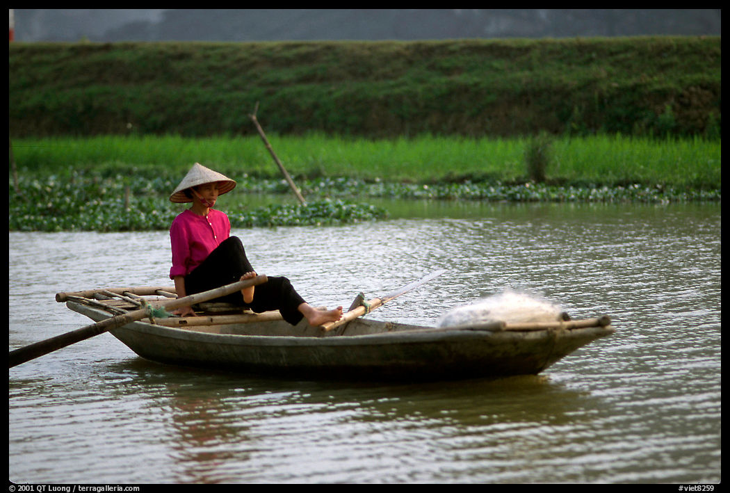 The local technique of paddling with feet, Ken Ga canal. near Ninh Binh,  Vietnam